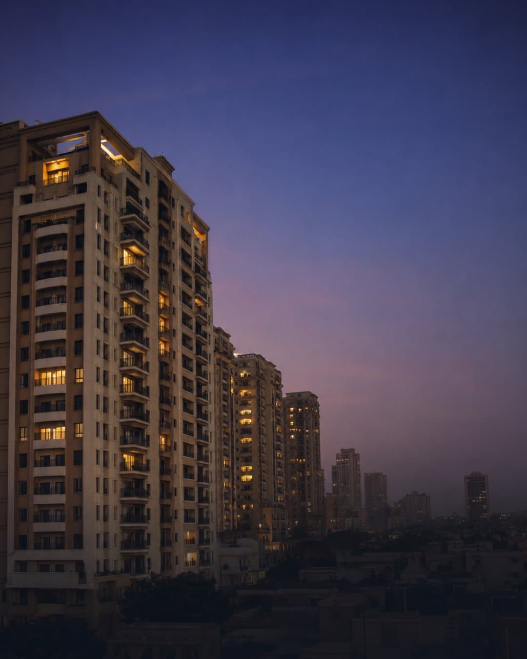 Gulshan-e-Iqbal apartment towers at twilight — Karachi residential skyline